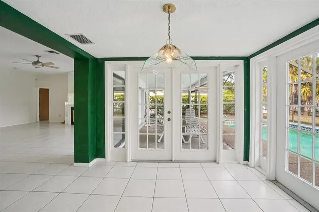 a view of an entryway with wooden floor and a chandelier