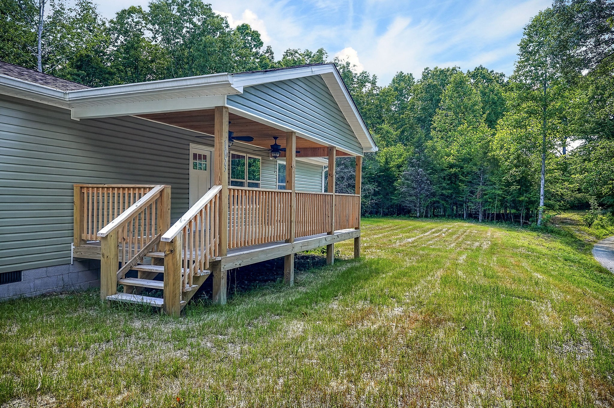 1053 Benton Tidwell Road Hilham, TN 38568 - Photo 22 of 39 a view of a house with a backyard and stairs