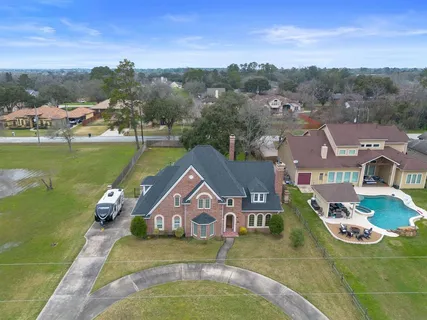 an aerial view of a house with a garden and lake view
