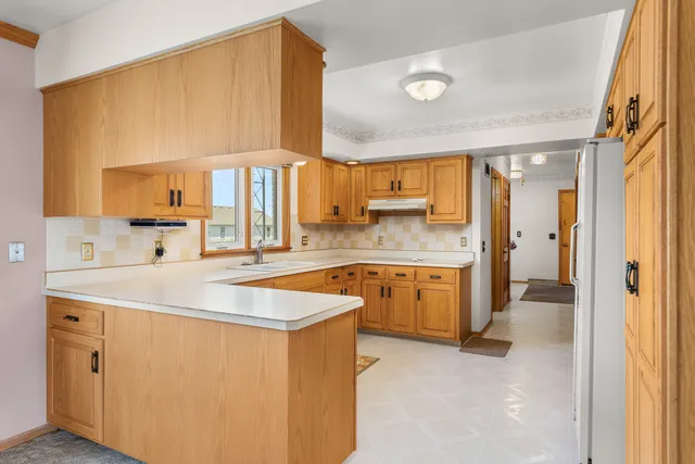 a kitchen with cabinets appliances and a window