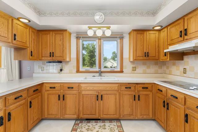 a bathroom with a sink a toilet and a window
