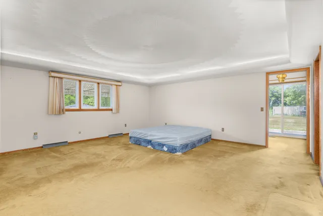 a bathroom with a granite countertop sink a toilet and shower