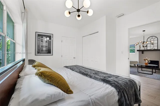 a bedroom with a large bed and a large window