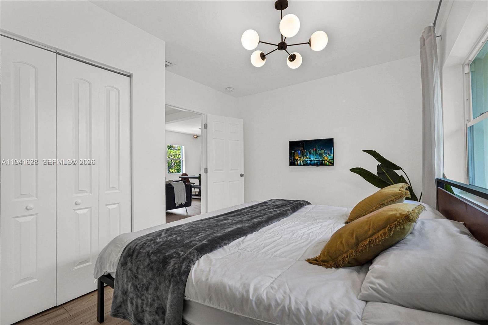 37 Northwest 47th Street Miami, FL 33127 - Photo 13 of 83 a bedroom with a bed and a chandelier