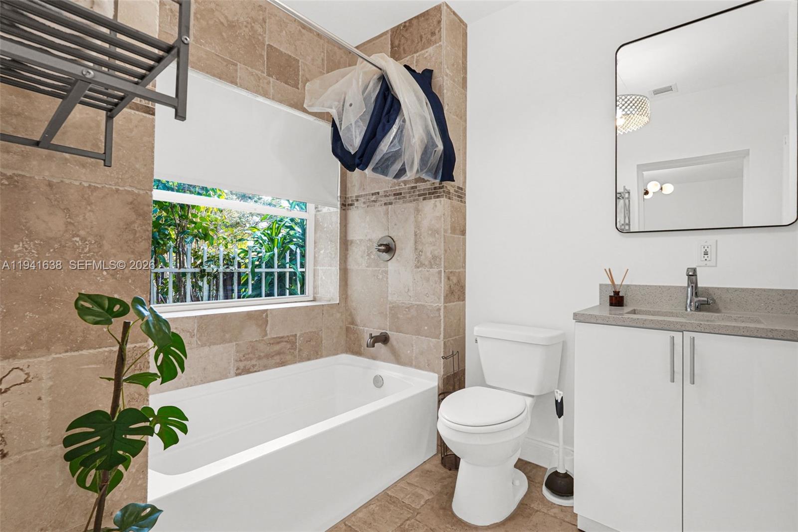 37 Northwest 47th Street Miami, FL 33127 - Photo 15 of 83 a bathroom with a sink a toilet and a bathtub