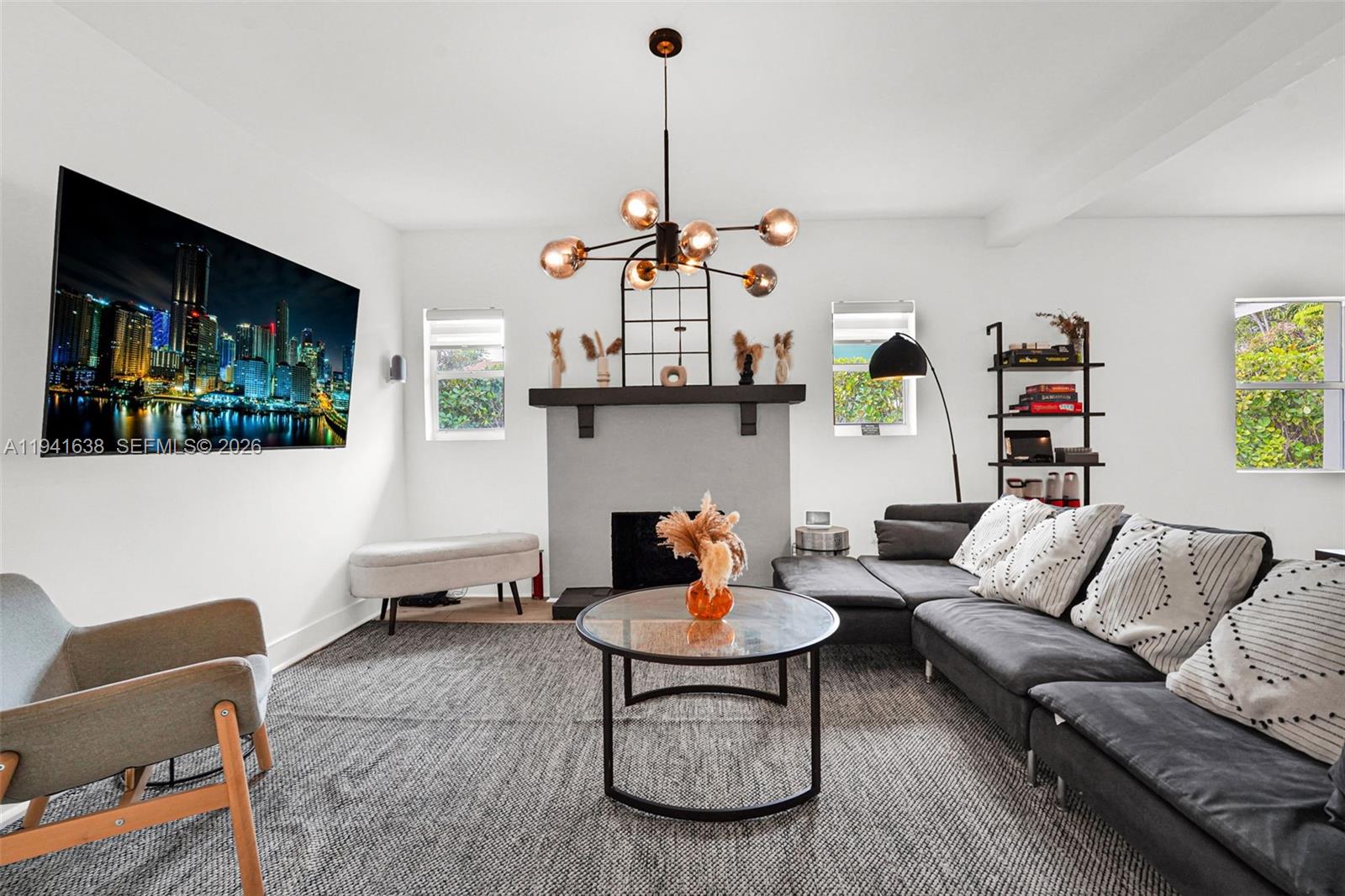 37 Northwest 47th Street Miami, FL 33127 - Photo 2 of 83 a living room with furniture and a flat screen tv