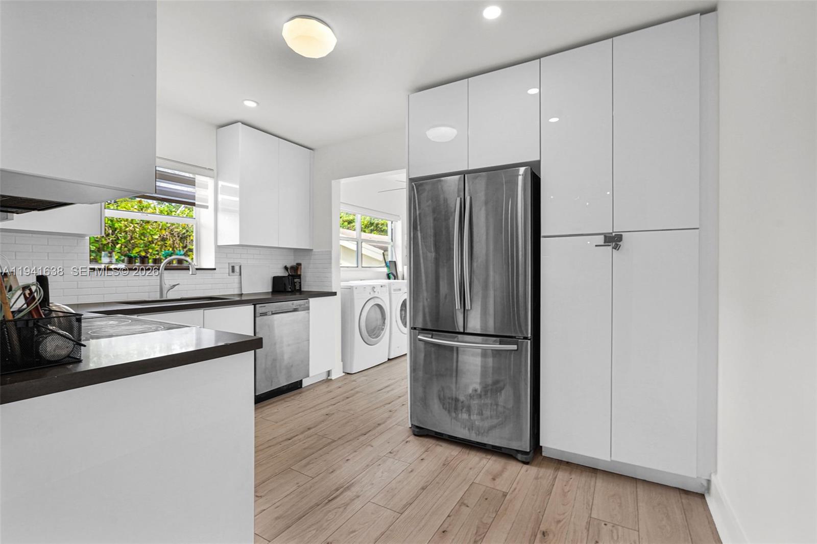 37 Northwest 47th Street Miami, FL 33127 - Photo 24 of 83 a kitchen with a refrigerator and a stove top oven