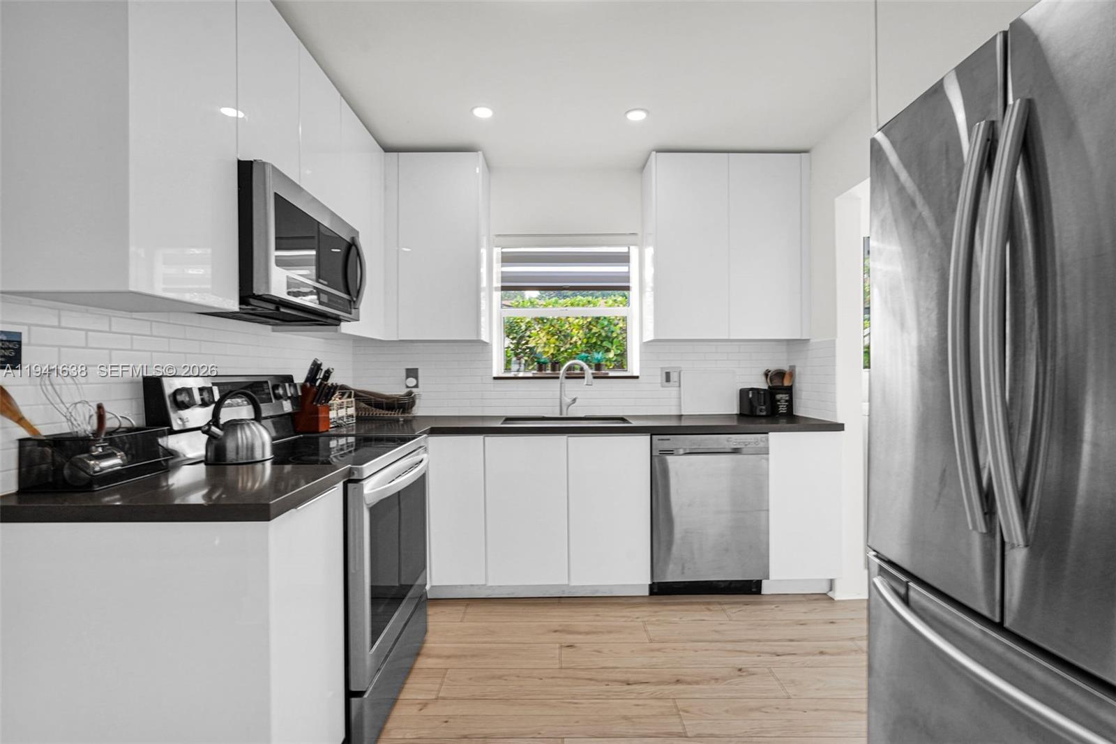 37 Northwest 47th Street Miami, FL 33127 - Photo 25 of 83 a kitchen with a refrigerator and a sink