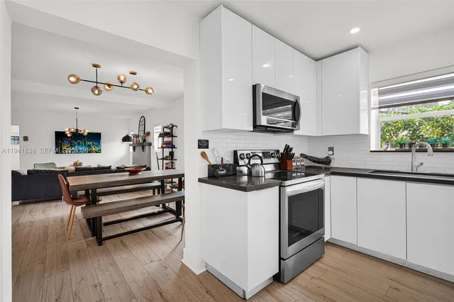 a spacious bathroom with a granite countertop sink and a mirror