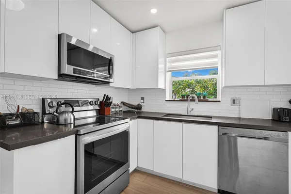 a spacious bathroom with a granite countertop sink and a mirror