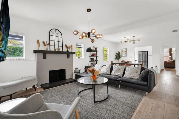 a living room with furniture and a fireplace