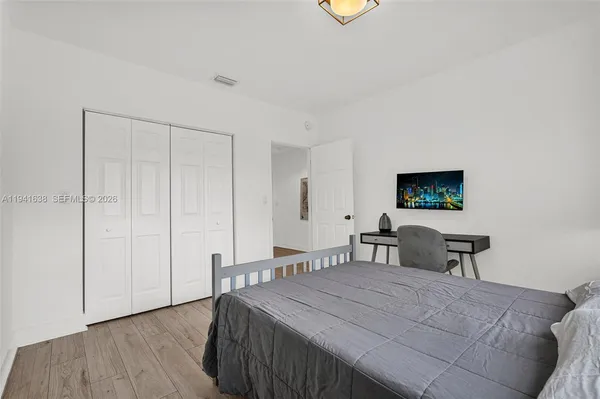 a view of a backyard with wooden fence