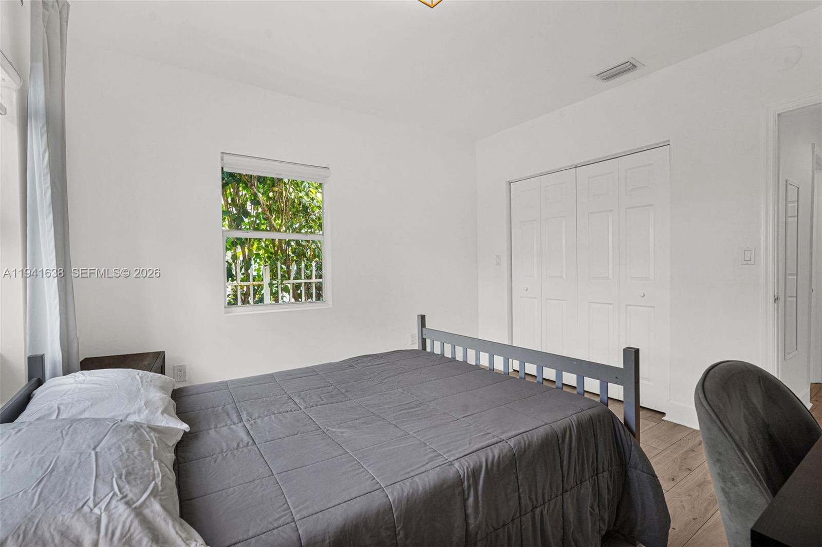 37 Northwest 47th Street Miami, FL 33127 - Photo 38 of 83 a bedroom with a bed and a chair