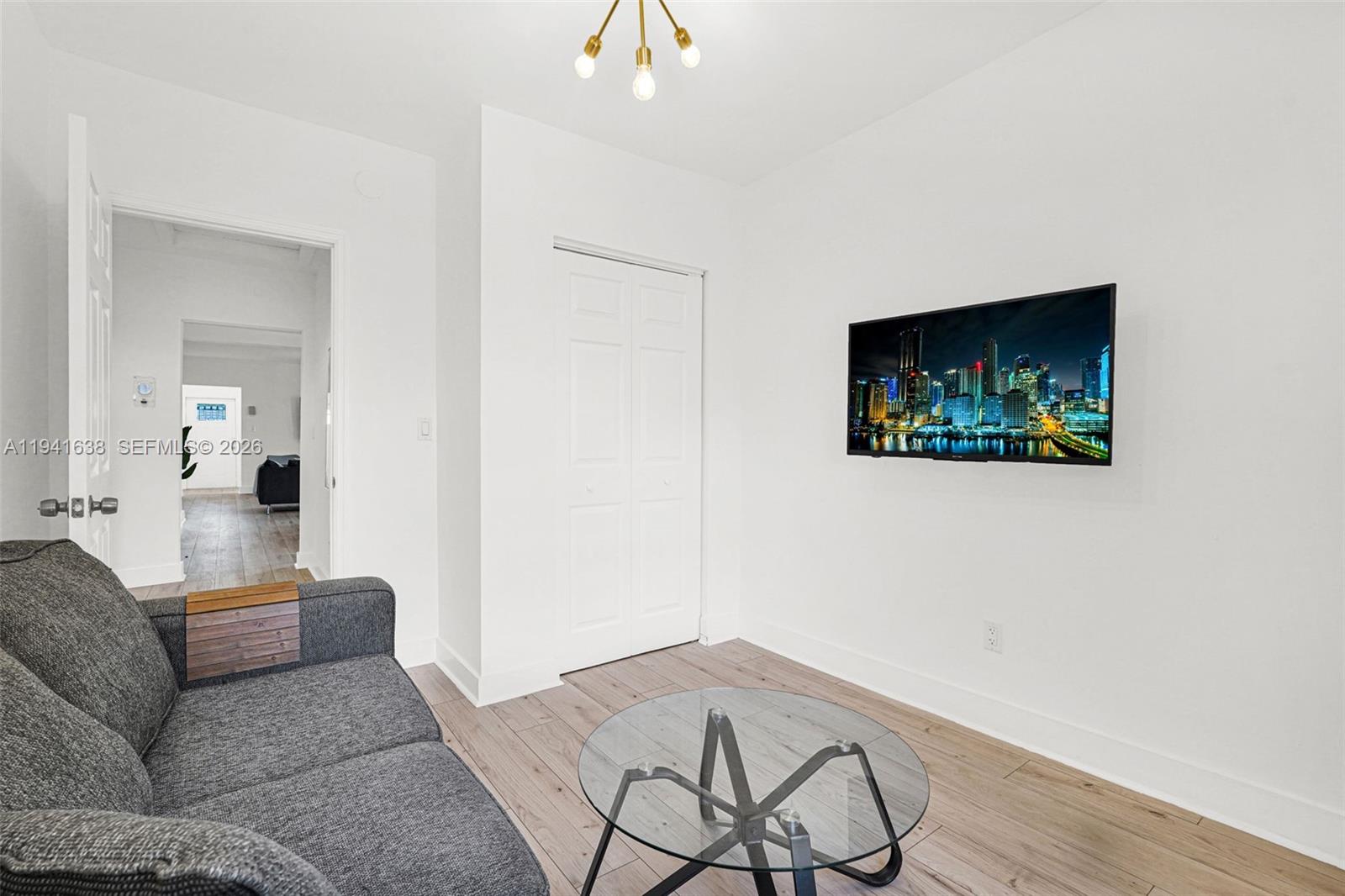 37 Northwest 47th Street Miami, FL 33127 - Photo 40 of 83 a living room with furniture and a flat screen tv