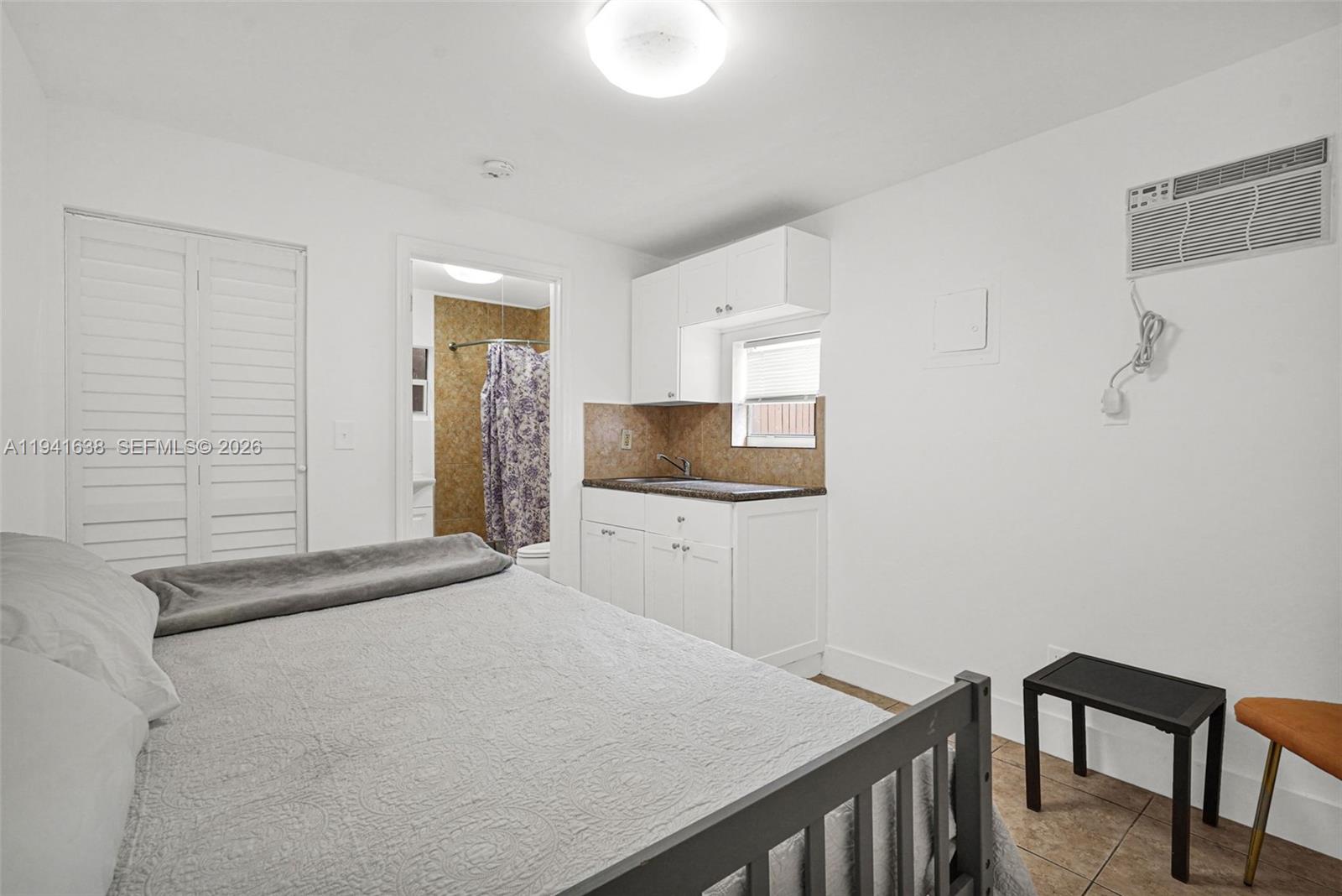 37 Northwest 47th Street Miami, FL 33127 - Photo 44 of 83 a bedroom with a table and chair