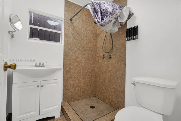 a front view of a house with a yard and plant