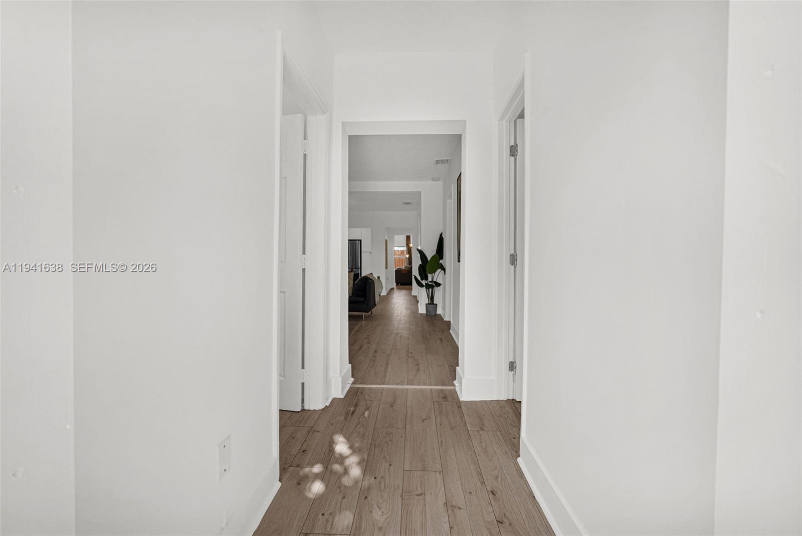 37 Northwest 47th Street Miami, FL 33127 - Photo 49 of 83 a view of a hallway with wooden floor