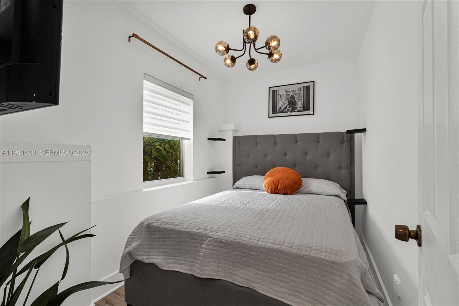 37 Northwest 47th Street Miami, FL 33127 - Photo 50 of 83 a bedroom with a bed and a flat screen tv