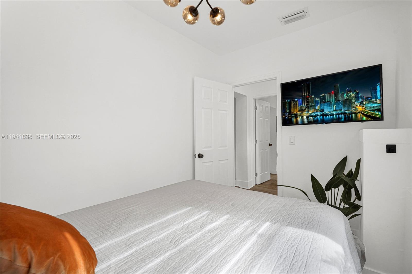 37 Northwest 47th Street Miami, FL 33127 - Photo 51 of 83 a bed room with a bed and a television