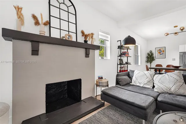 a living room with furniture a window and a flat screen tv
