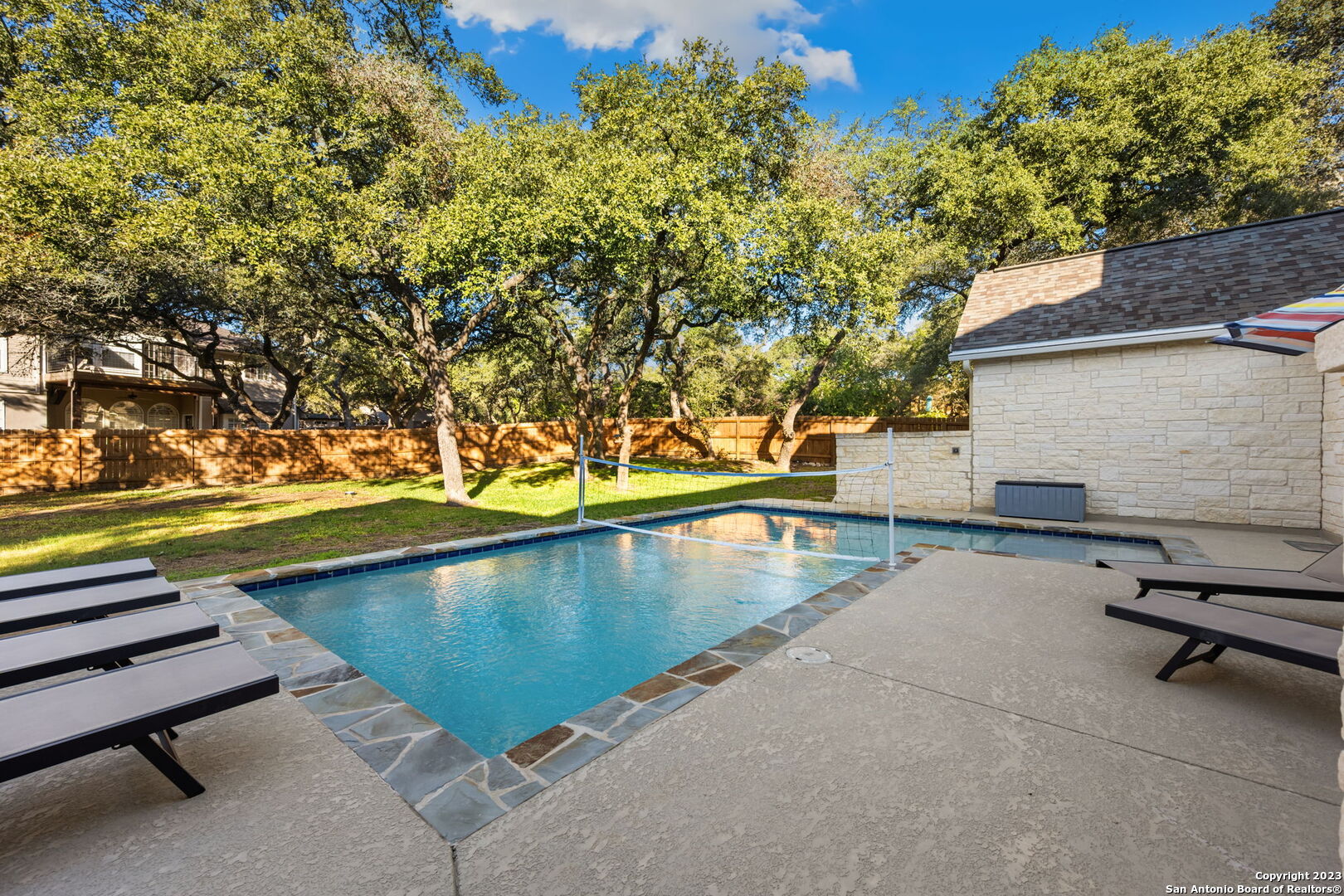 a view of swimming pool with outdoor seating and a yard