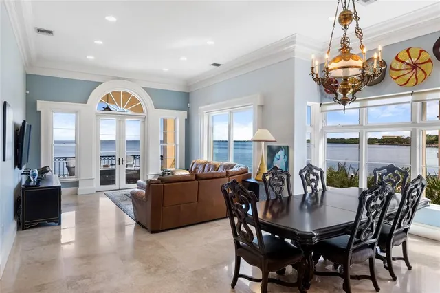 a living room with furniture a large window and a flat screen tv