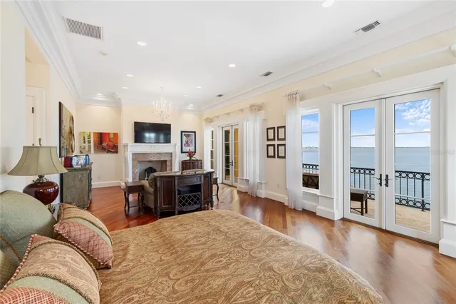 a bedroom with a bed and a chandelier