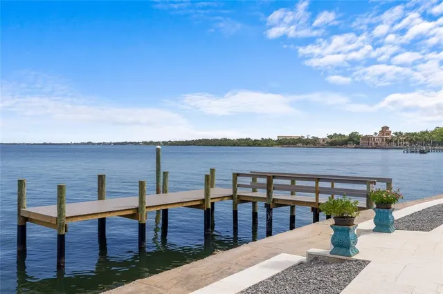 a roof deck with table and chairs