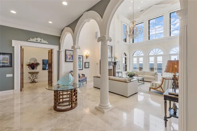 a living room with furniture a fireplace and a large window