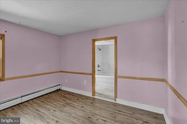 a view of a room with wooden floor