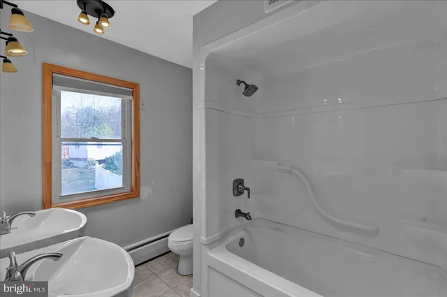 a white bath tub sitting next to a toilet