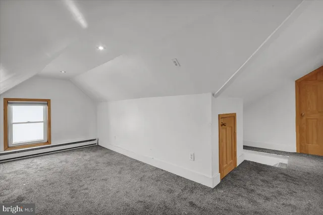 an empty room with a empty space and windows