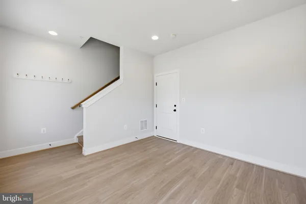 a view of an empty room with wooden floor