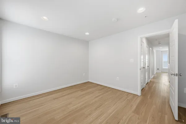 a view of a room with wooden floor