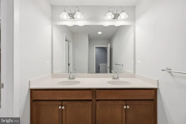 a bathroom with a sink vanity and a mirror