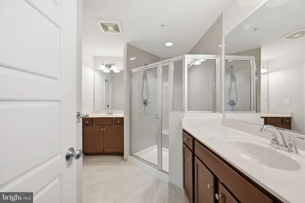a bathroom with a granite countertop sink mirror and double