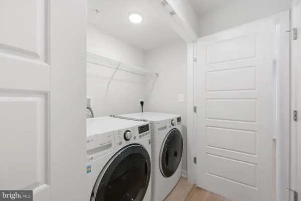 a view of storage and utility room with washer and dryer
