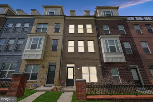 a front view of a residential apartment building with a yard