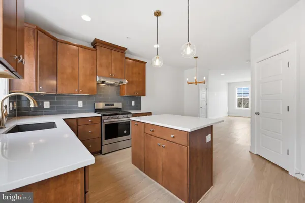 a kitchen with a stove sink and refrigerator