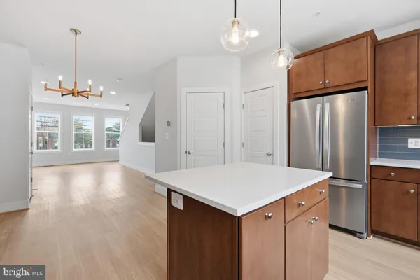a kitchen with kitchen island white cabinets and stainless steel appliances