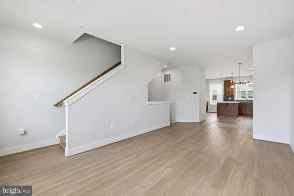 a view of a kitchen with a sink and a refrigerator