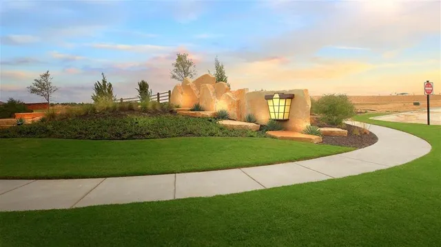 a view of a garden with a building in the background