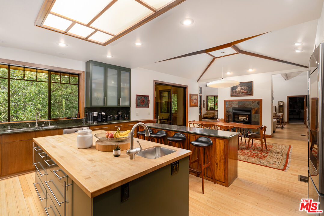 25445 Fern Valley Road Idyllwild, CA 92549 - Photo 11 of 45 a kitchen with a counter top space a sink appliances and a large window