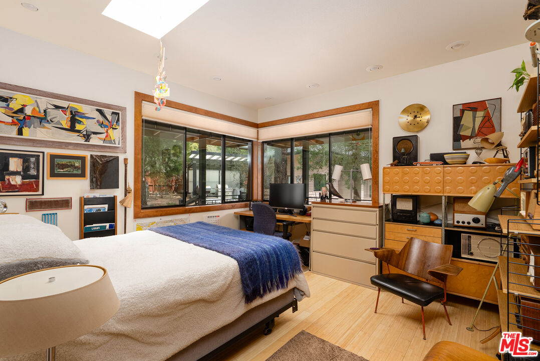 25445 Fern Valley Road Idyllwild, CA 92549 - Photo 22 of 45 a spacious bedroom with a bed and a large window