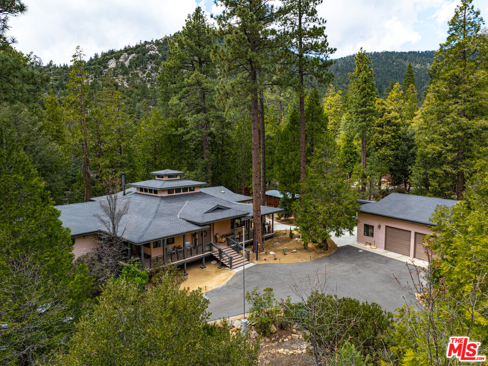 25445 Fern Valley Road Idyllwild, CA 92549 - Photo 43 of 45 a view of a patio with table and chairs potted plants and large trees