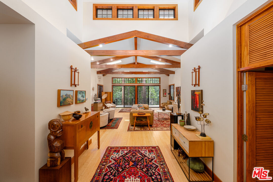 25445 Fern Valley Road Idyllwild, CA 92549 - Photo 7 of 45 a living room with furniture fireplace and a large window