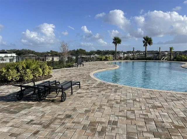 a view of a house with pool and a yard