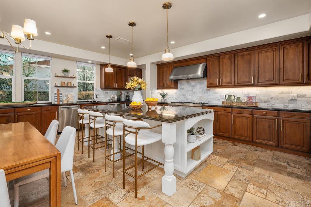 7603 Circulo Sequoia Carlsbad, CA 92009 - Photo 13 of 61 a kitchen with stainless steel appliances granite countertop a stove a sink a microwave and a refrigerator
