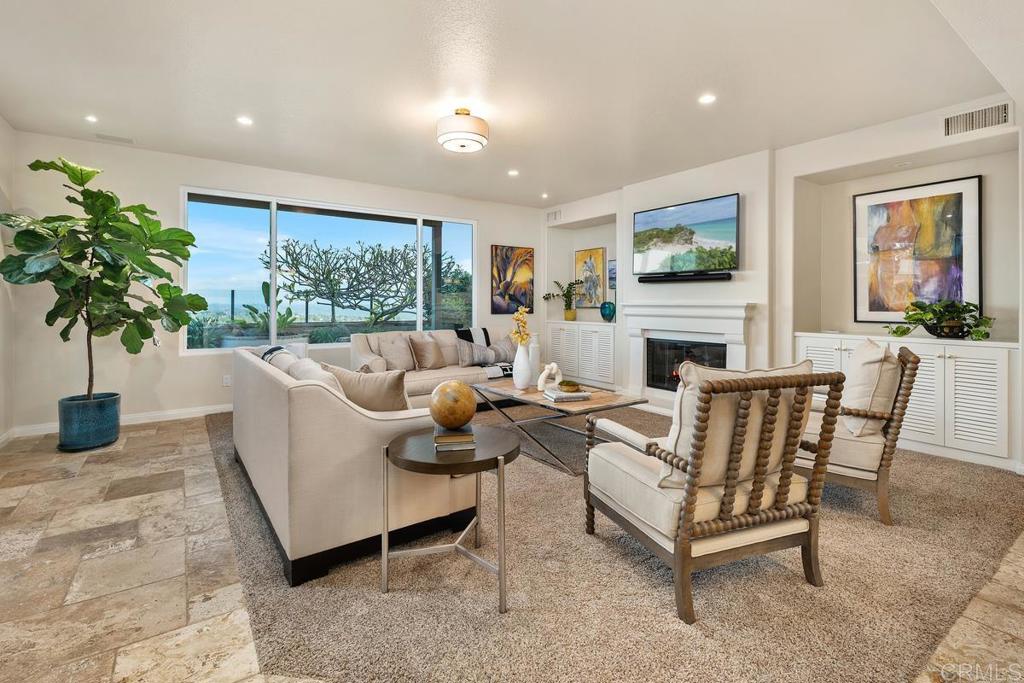 7603 Circulo Sequoia Carlsbad, CA 92009 - Photo 16 of 61 a living room with furniture a large window and a fireplace