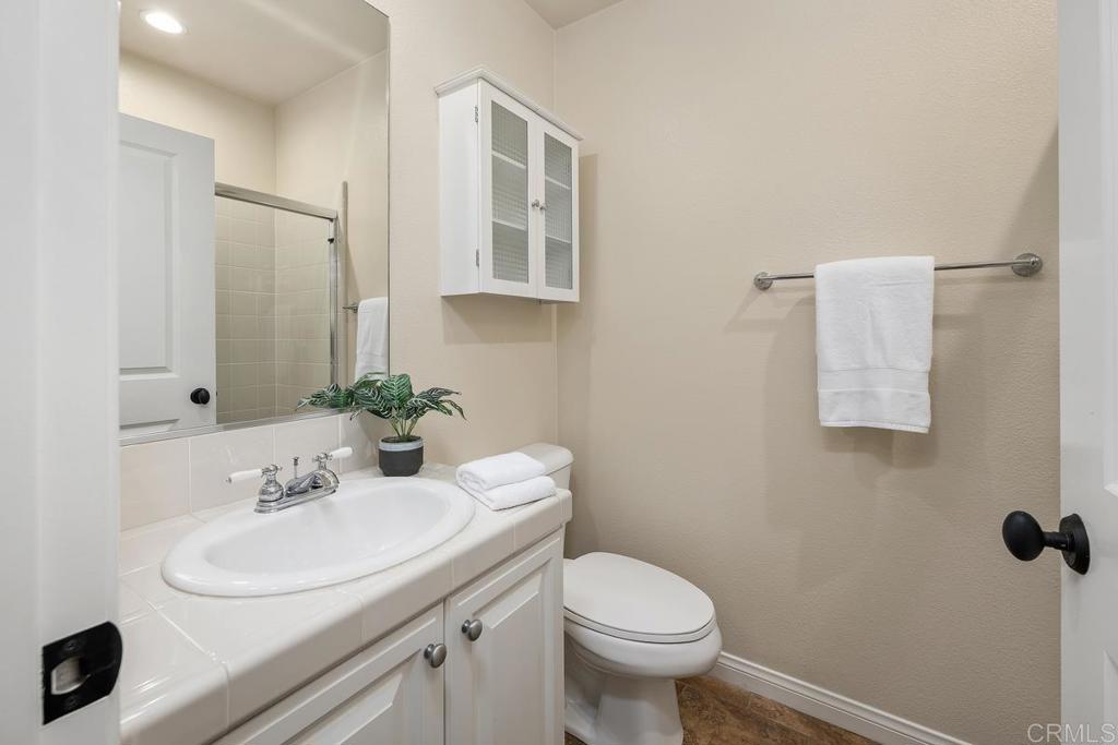7603 Circulo Sequoia Carlsbad, CA 92009 - Photo 19 of 61 a bathroom with a sink toilet and a mirror